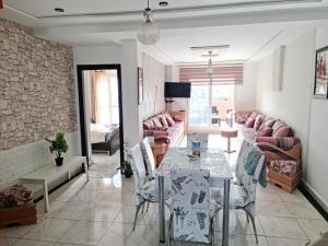 a living room with a table and chairs at FamilyConfort Saidia in Saïdia