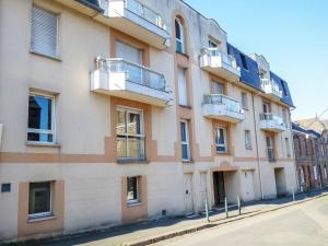 un edificio de apartamentos con balcones en una calle en Apartment Le Hoche by Interhome, en Dinard