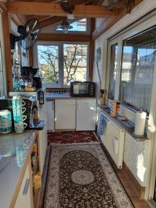 a kitchen with white cabinets and a large window at Luxus Ferienwohnung in Pfungstadt