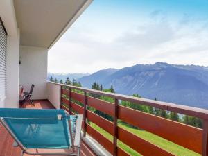 a balcony with a chair and a view of mountains at Apartment La Clairière des Barzettes A-B-7 by Interhome in Vermala