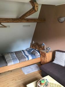 1 dormitorio con 1 cama y 1 sofá en Pension Schneidenbach en Reichenbach im Vogtland