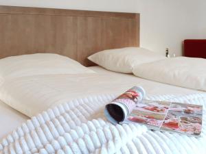 a bottle of wine sitting on top of a bed at Holiday Home Entenhaus II by Interhome in Ediger-Eller