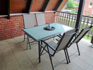 a blue table and chairs on a patio at Apartment Alina by Interhome in Marienhafe