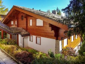 a house with a wooden roof at Apartment Soldanella by Interhome in Crans-Montana
