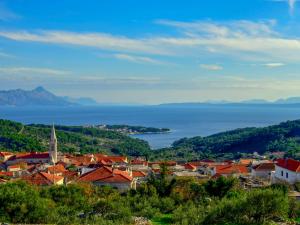 a view of a town with a church and the ocean at Holiday Home Ivana by Interhome in Selca