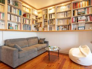 a living room with a couch and bookshelves at Apartment Ker Louis 2 by Interhome in Dinard