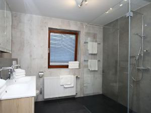 a bathroom with a shower and a sink and a mirror at Apartment Schwarzwald by Interhome in Radenthein