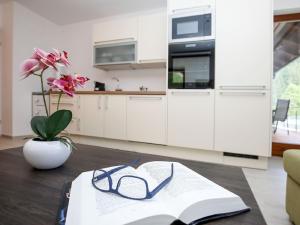 stół z książką i okularami w obiekcie Apartment Schwarzwald 6 OG by Interhome w mieście Radenthein