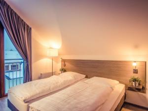 Een bed of bedden in een kamer bij Holiday Home Residence Lipno by Interhome