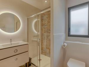 a bathroom with a shower and a sink and a mirror at Holiday Home L'allée Couverte by Interhome in La Trinité-sur-Mer