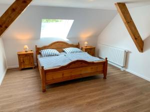 a bedroom with a wooden bed and two night stands at Apartment Spiekeroog by Interhome in Westerholt