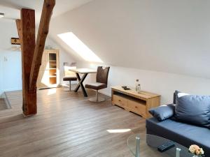 a living room with a blue couch and a table at Apartment Baltrum by Interhome in Westerholt
