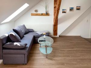 a living room with a couch and a glass table at Apartment Baltrum by Interhome in Westerholt