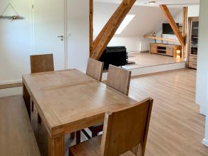 a dining room with a wooden table and chairs at Apartment Borkum by Interhome in Westerholt