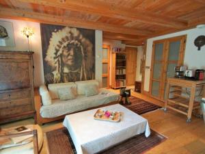 ein Wohnzimmer mit einem Sofa und einem Gemälde an der Wand in der Unterkunft Apartment Les Jardins de l'Astoria by Interhome in Chamonix-Mont-Blanc