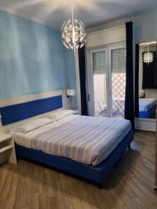 a bedroom with a bed and a window at Palafiori Rooms Sanremo in Sanremo