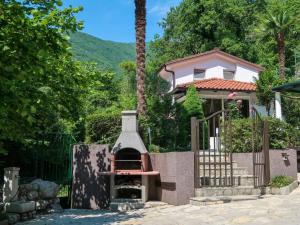 a house with a fireplace in front of it at Holiday Home Karin by Interhome in Lovran
