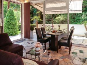 a living room with a table and chairs at Holiday Home Karin by Interhome in Lovran