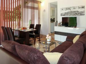 a living room with a couch and a dining room at Holiday Home Karin by Interhome in Lovran +31 photos