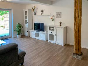 a living room with a couch and a television at Apartment Wangerooge by Interhome in Westerholt