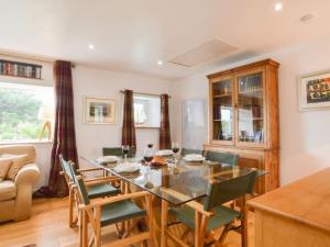 a dining room with a glass table and chairs at Holiday Home Easdale Cottage by Interhome in Oban