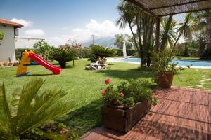 a yard with a playground with a slide at B&B La Taverna dei Ciucci in Foce del Sele