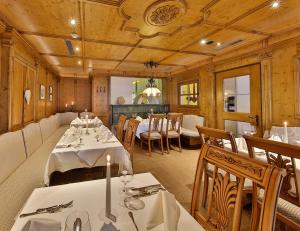 a dining room with tables and chairs in a restaurant at Familienhotel Post in Serfaus