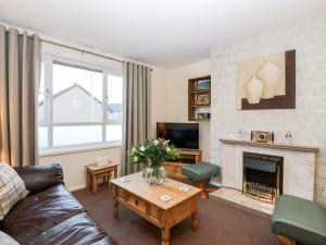 a living room with a couch and a fireplace at 10 Annesley Park in Banchory