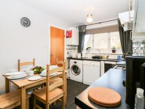 a kitchen with a table and a dining room at 10 Annesley Park in Banchory