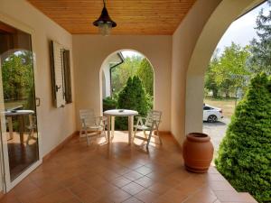 un porche con mesa y sillas en Villa Angela Santa Maria del Molise, en Santa Maria del Molise