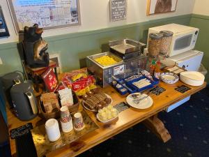 a table topped with a variety of food items at Cinnamon Bear Inn in Mammoth Lakes