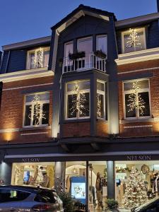 a store front with a christmas tree in the window at The first Harmony in Spa