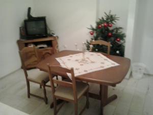 a dining room table with chairs and a christmas tree at Apartment Ljilja in Dubrovnik