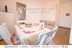 a room with a table and chairs and a couch at Casa Biltu in Lavagna