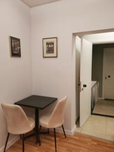 a dining room with a black table and chairs at St Moscow Suites Taksim in Istanbul