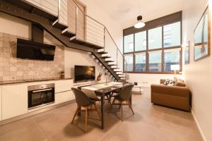 a living room with a table and chairs and a staircase at Lake Home Holiday in Como