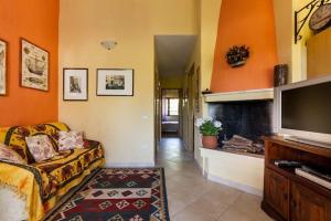 a living room with a couch and a flat screen tv at Casa Marcella in Costa Rei