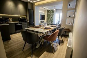 a kitchen and dining room with a table and chairs at The Lux2 a gorgeous apartment in Thessaloniki