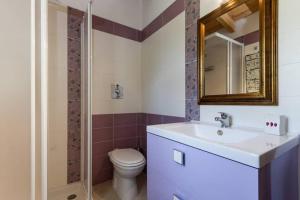 a bathroom with a sink and a toilet and a mirror at Casa Marcella in Costa Rei +18 photos