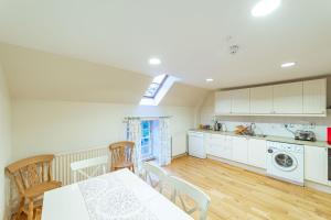 a kitchen and dining room with a table and chairs at Wallace Apartment in Newton Stewart