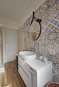 baño con lavabo y espejo en la pared en Casa Mare d'Arancio, en Bordighera
