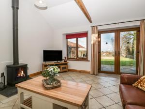a living room with a couch and a fireplace at The Hide in Bridgwater