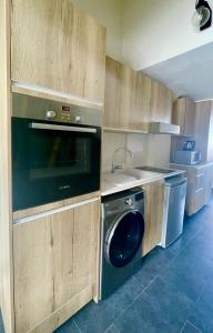 a kitchen with a washing machine and a sink at Centr'Hotel in Marigot