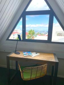 a desk with a lamp in front of a window at Centr'Hotel in Marigot