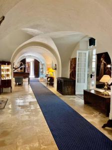 a living room with a blue carpet and a piano at Château de Floure - SPA et piscine extérieure chauffée in Carcassonne +102 photos