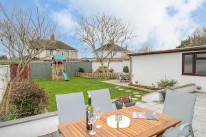 a patio with a table and chairs in a yard at Family House in Weymouth