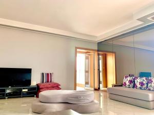 a living room with a couch and a tv at Anfa 118 - Best view in town - 3 bedrooms - 2 Bathrooms in Casablanca +8 photos