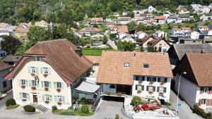 an aerial view of a town with houses and a red car at Gasthof Kreuz Egerkingen in Egerkingen