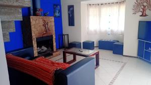 a living room with a couch and a fireplace at La soñada in Mar Azul