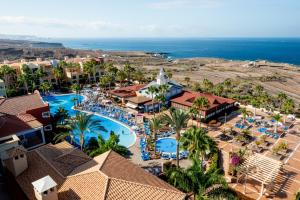 an aerial view of a resort with a pool and the ocean at Bahia Principe Sunlight Tenerife in Adeje